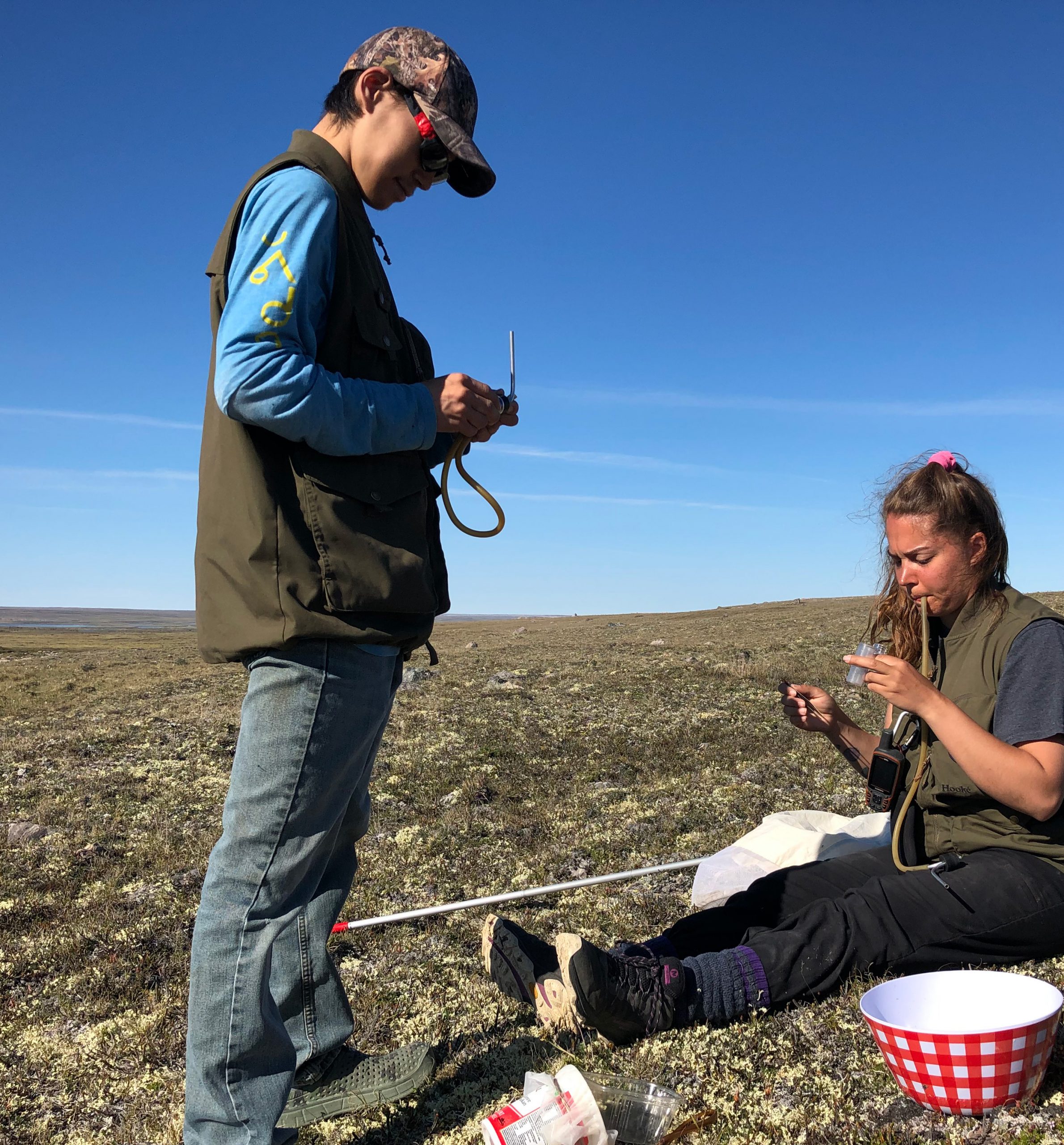 Field technicians Kumau and Kristen sampling arthropods in Kugaaruk, Nunavut.